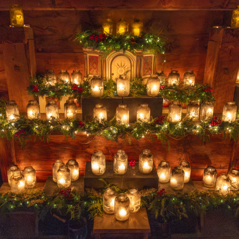 dozens of glowing mason jars illuminating the altar in the church 