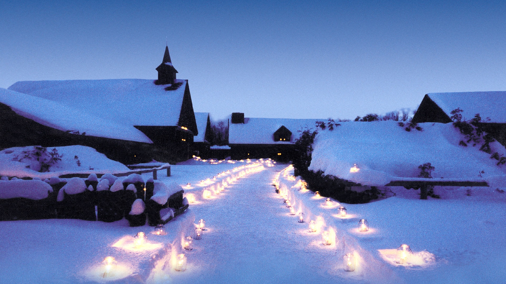 Sainte-Marie covered in snow, lit by candles