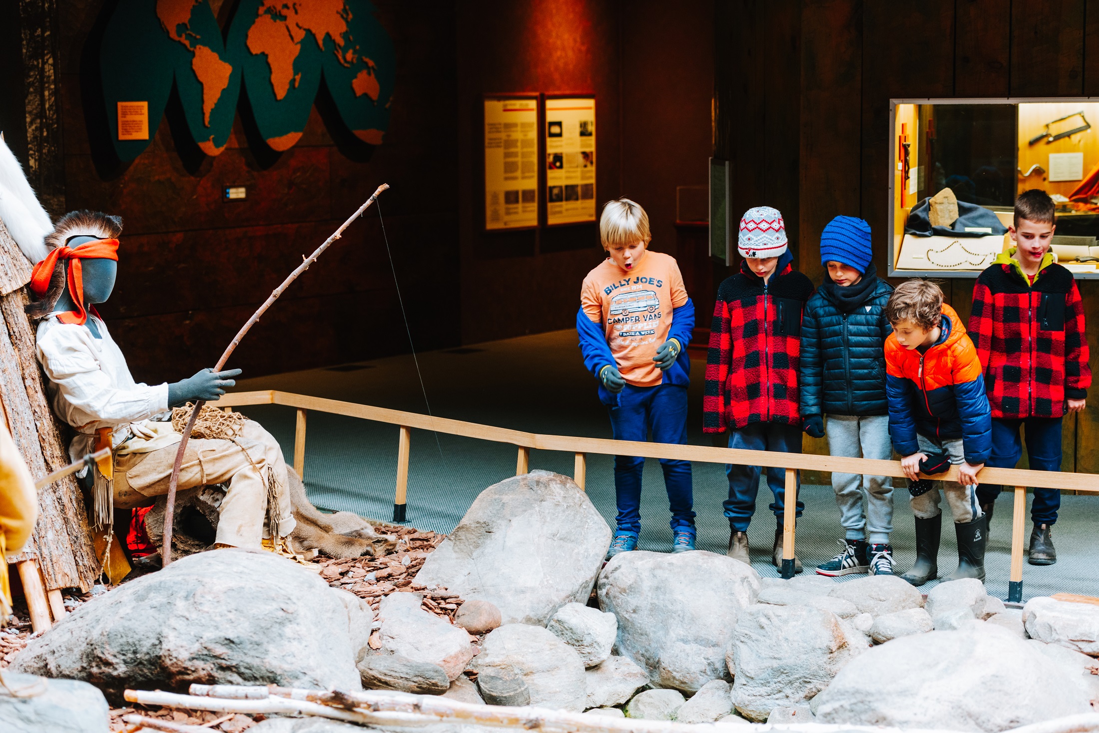 Five kids admiring a display in the museum