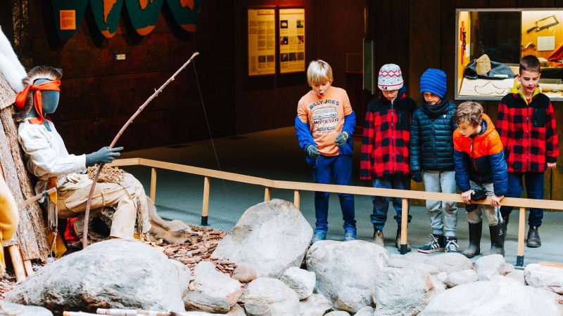 Five kids admiring a display in the museum