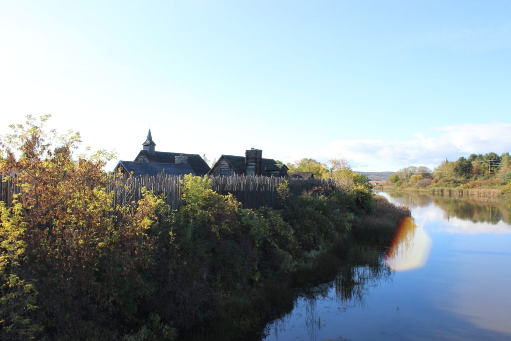 La rivière Wye avec les murs de Sainte-Marie-au-pays-des-Hurons. Les toits des édifices historiques sont visibles.