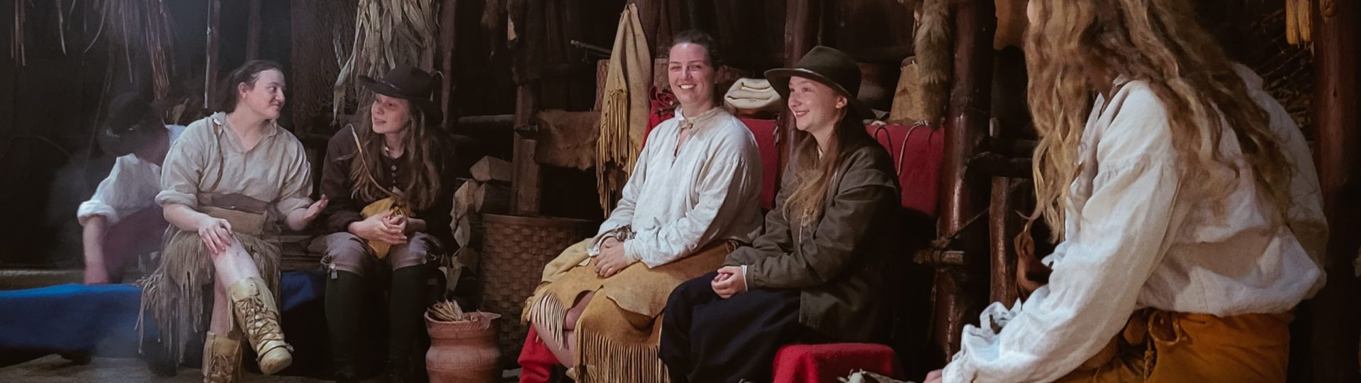 Interpreters laughing and talking in a longhouse 