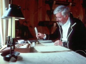 Naval Surveyor writing at their desk
