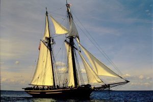 HMS Tecumseth side view on open water with sails open