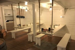 two floating tables with benches inside of the HMS Tecumseth