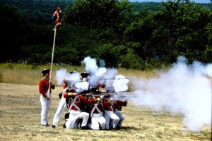 Musket firing drill practice with a group British soldiers (reenactment)