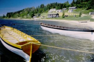 two smaller vessels floating in shallow water